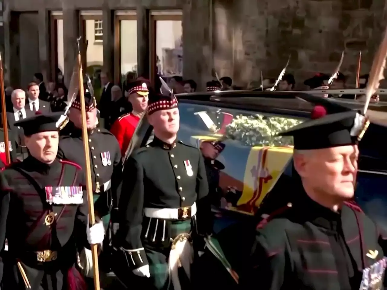 TEARFUL PROCESSION: Mourners line street as the coffin of the late QUEEN Elizabeth II passes