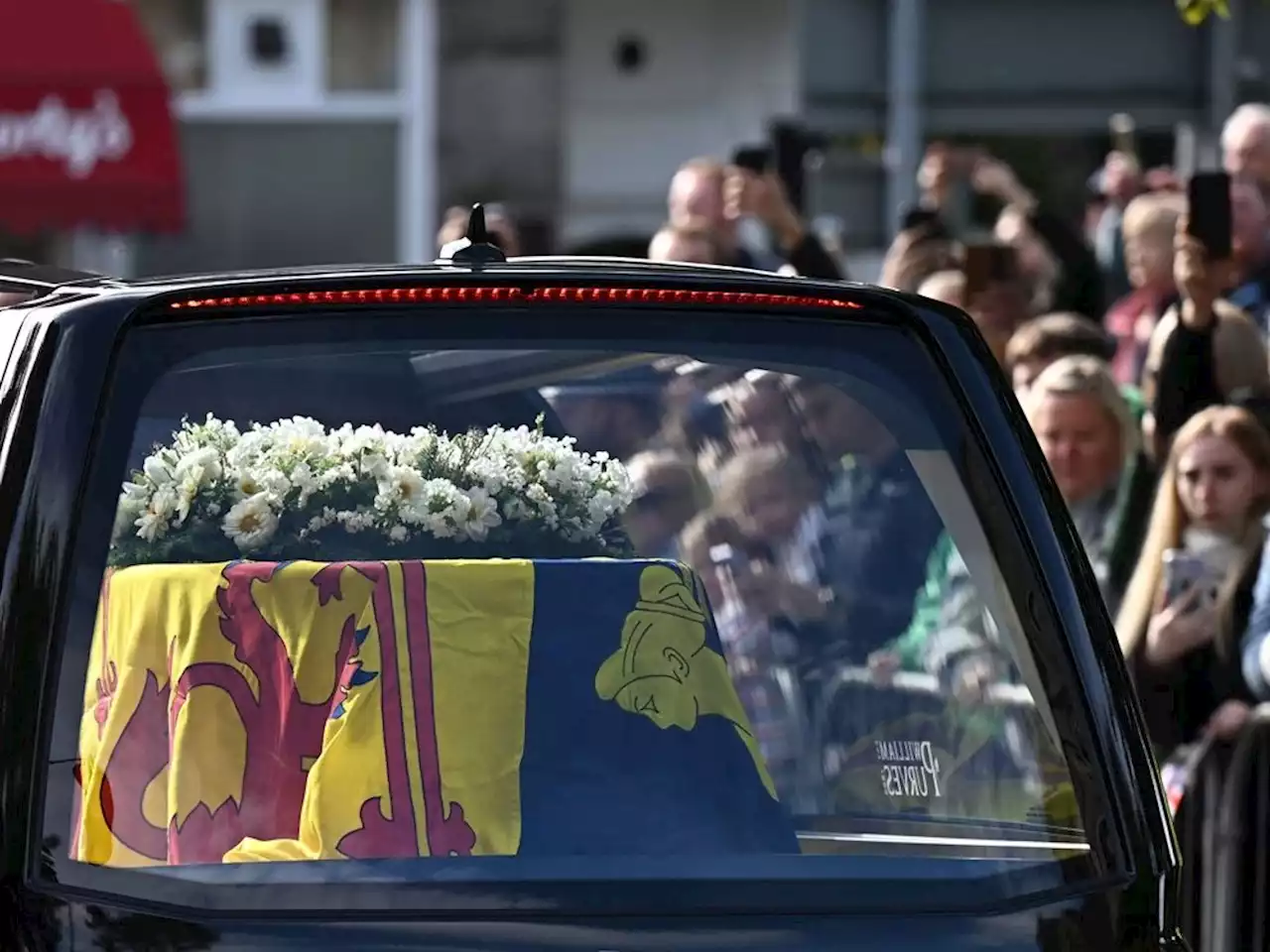 In solemn procession, Queen Elizabeth's coffin is taken through Edinburgh