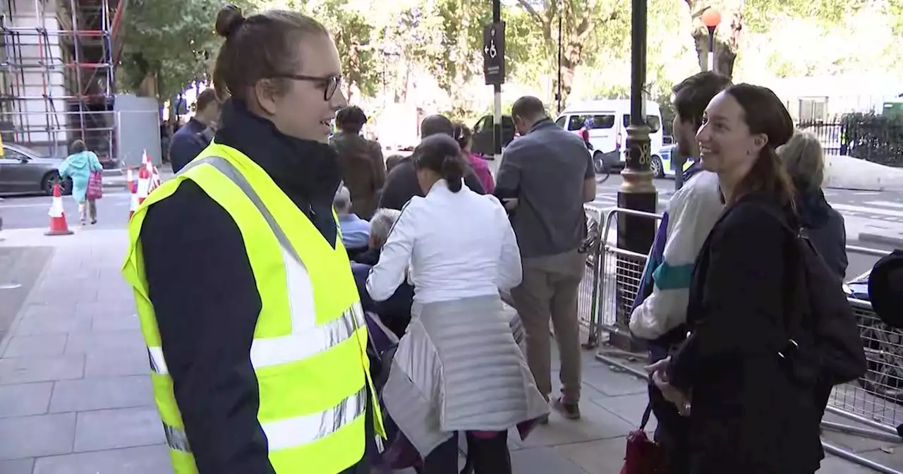 Scouts help keep up morale for those waiting in line to see Queen Elizabeth II's coffin