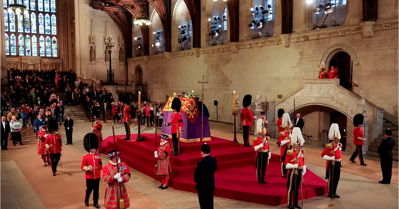 Live updates: Bidens pay their respects at queen's coffin