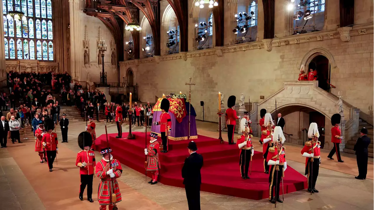 Live updates: Bidens pay their respects at queen's coffin