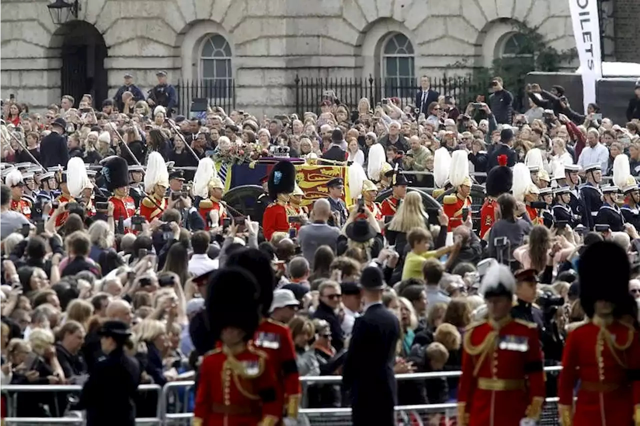 Huge crowds follow queen's funeral in silence and awe