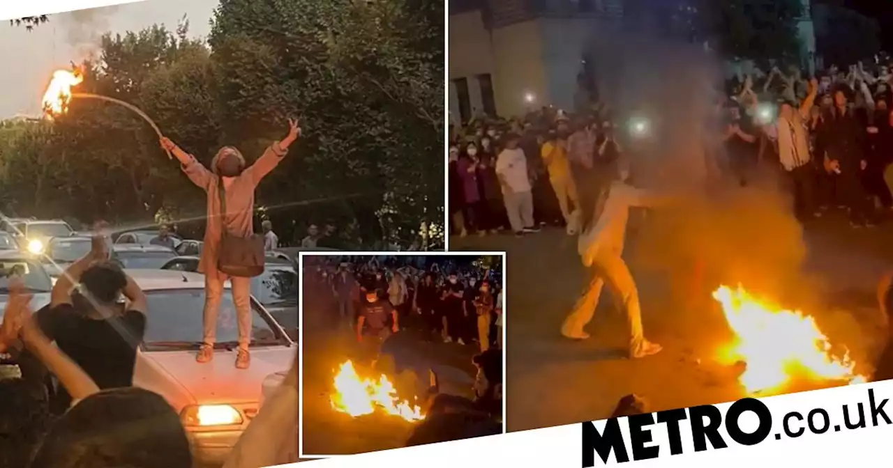 Women burn headscarves on bonfires after anti-hijab protests escalate in Iran