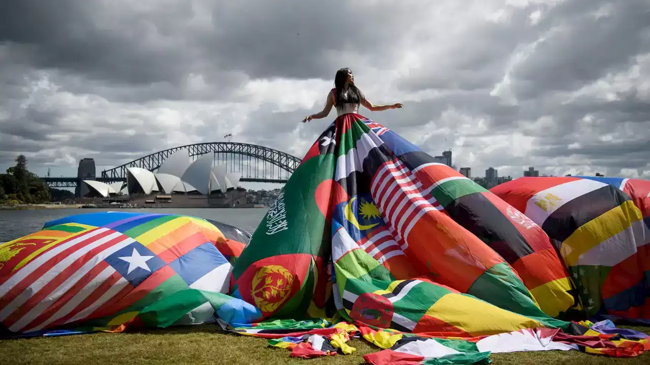 Why a giant dress made out of 71 nations' flags is on display in Sydney