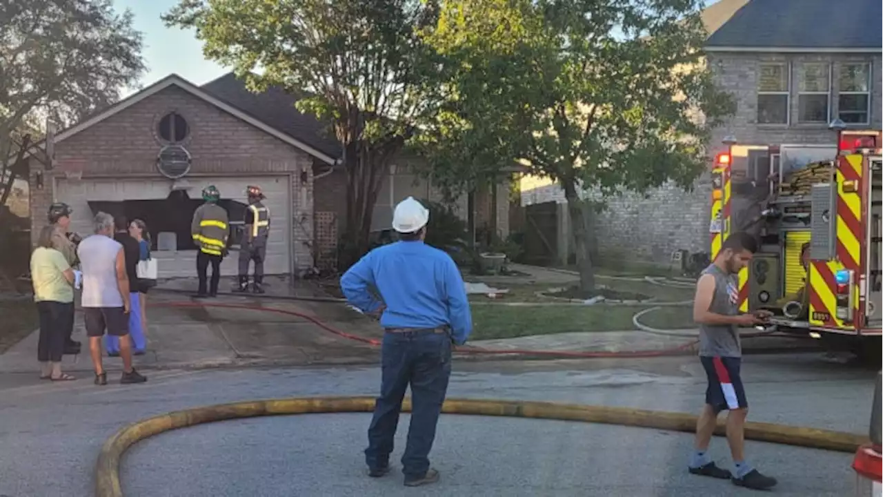 Crews battling fire make unusual entry into home by cutting huge hole in garage door