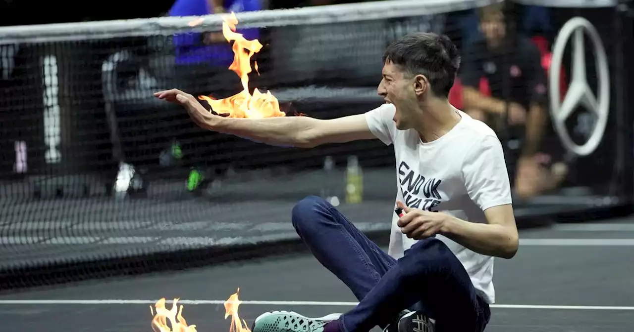 Protester at Laver Cup sets the court and his arm on fire