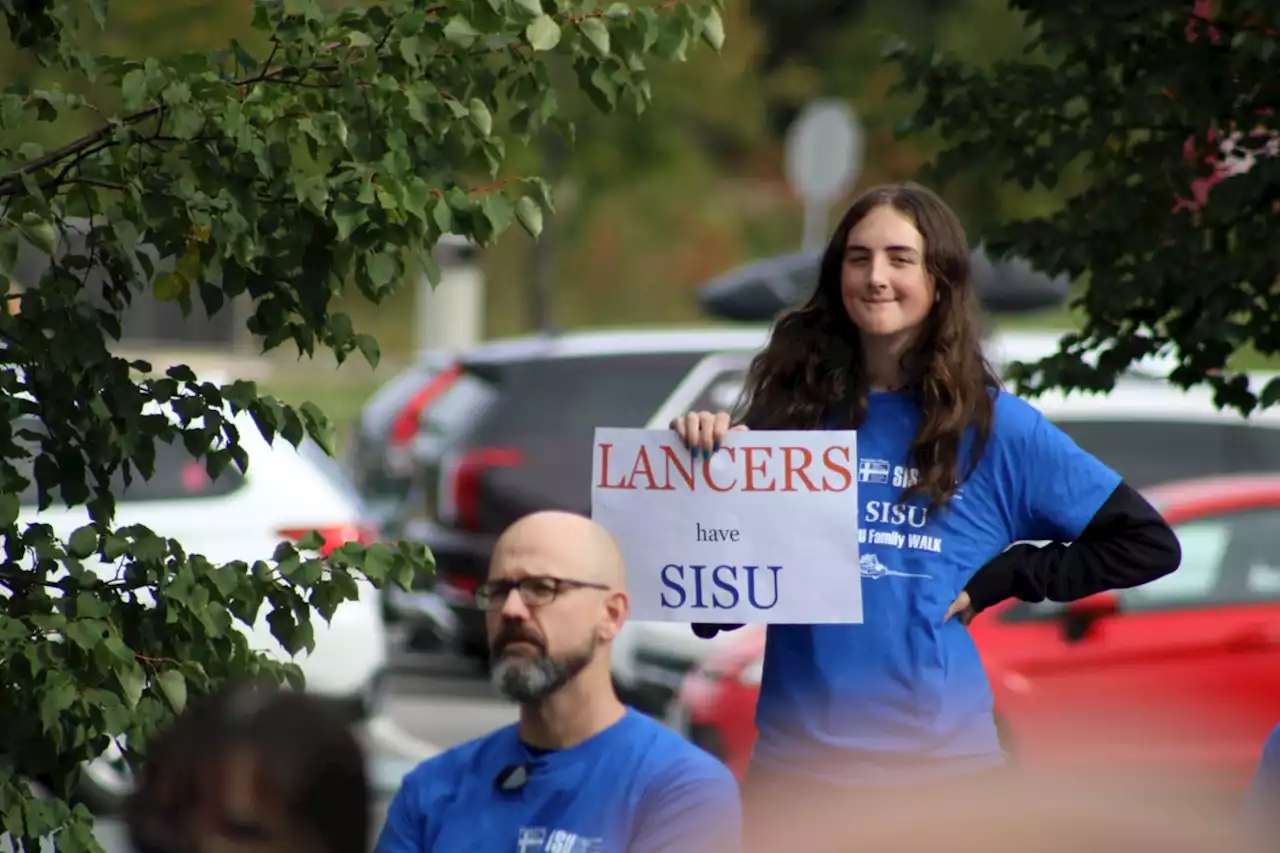 Students show support for seniors with walk to Finlandia Village