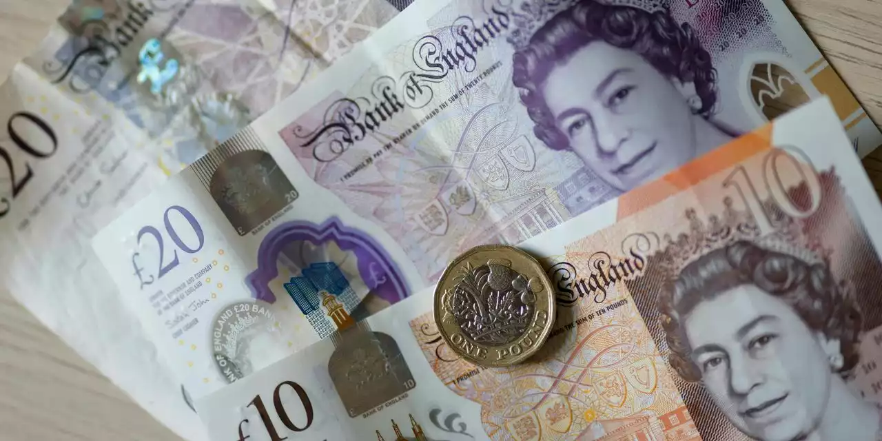 British pound hits record low, then pares losses, as investors react to tax-cut plan