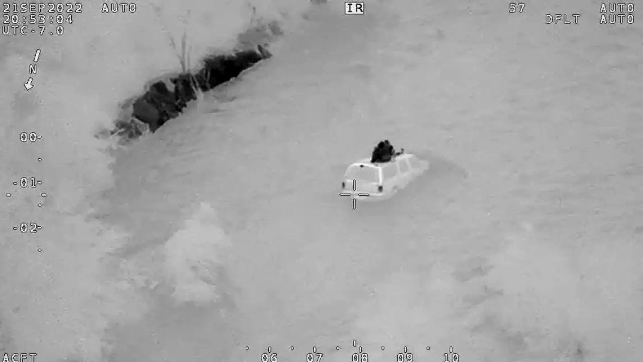 Nighttime water rescue of family stuck in flooded wash captured on camera by Arizona authorities