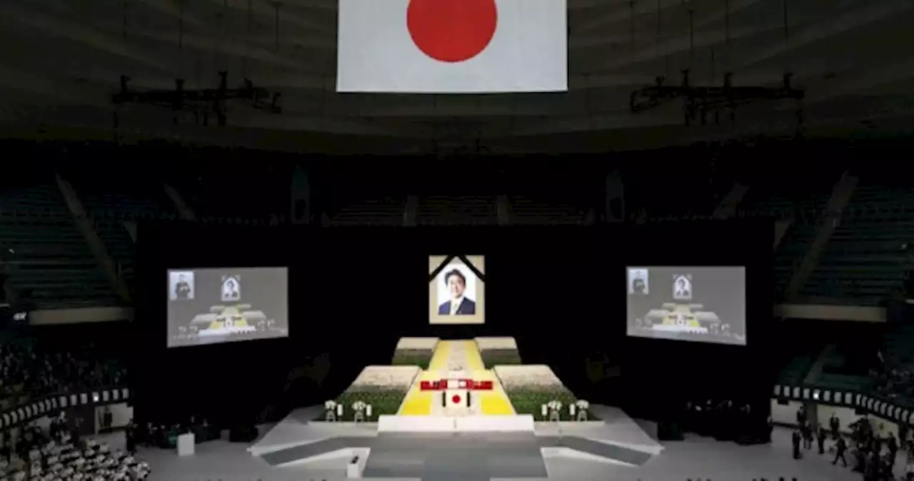 With flowers and a gun salute, Japan bids farewell to divisive Abe