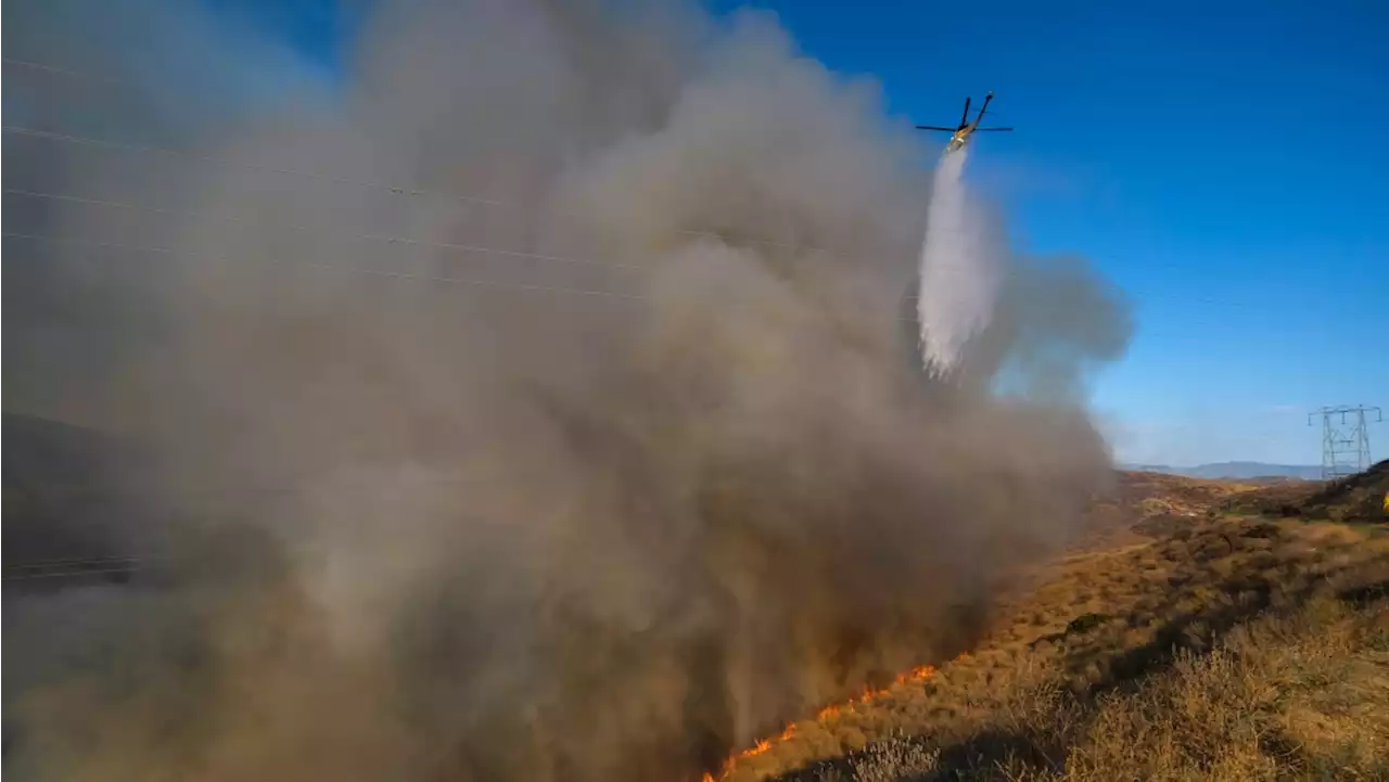 California fire fight persists as many neighbourhoods reopen