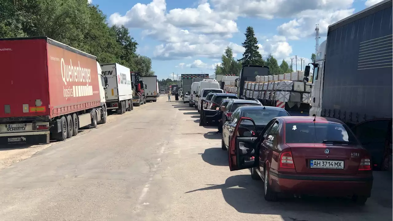 At Latvia's border with Russia, the line grows long, and tempers short