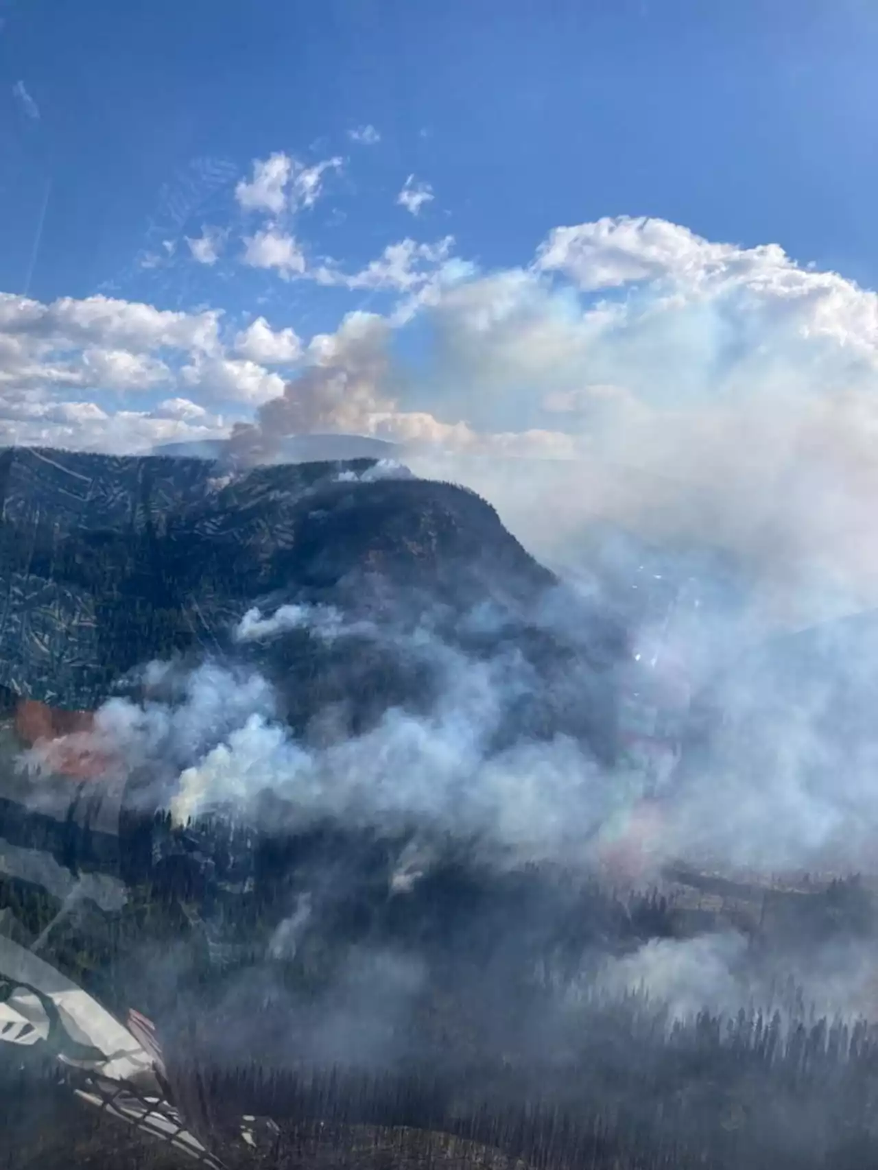 Crews keep close watch on one B.C. wildfire, as another delays school in northeast