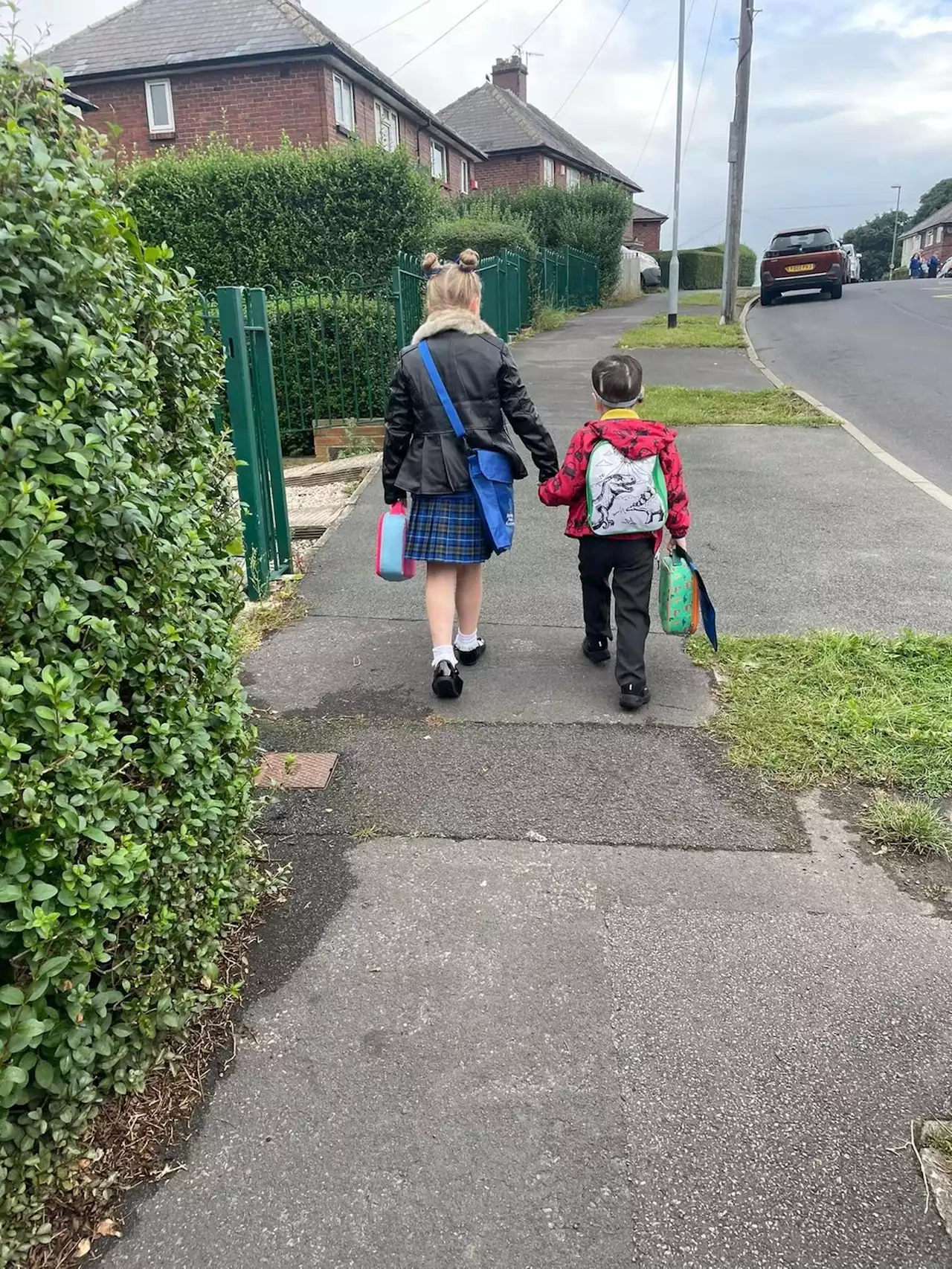 Defiant four-year-old starts school four months after terminal diagnosis holding hands with proud sister