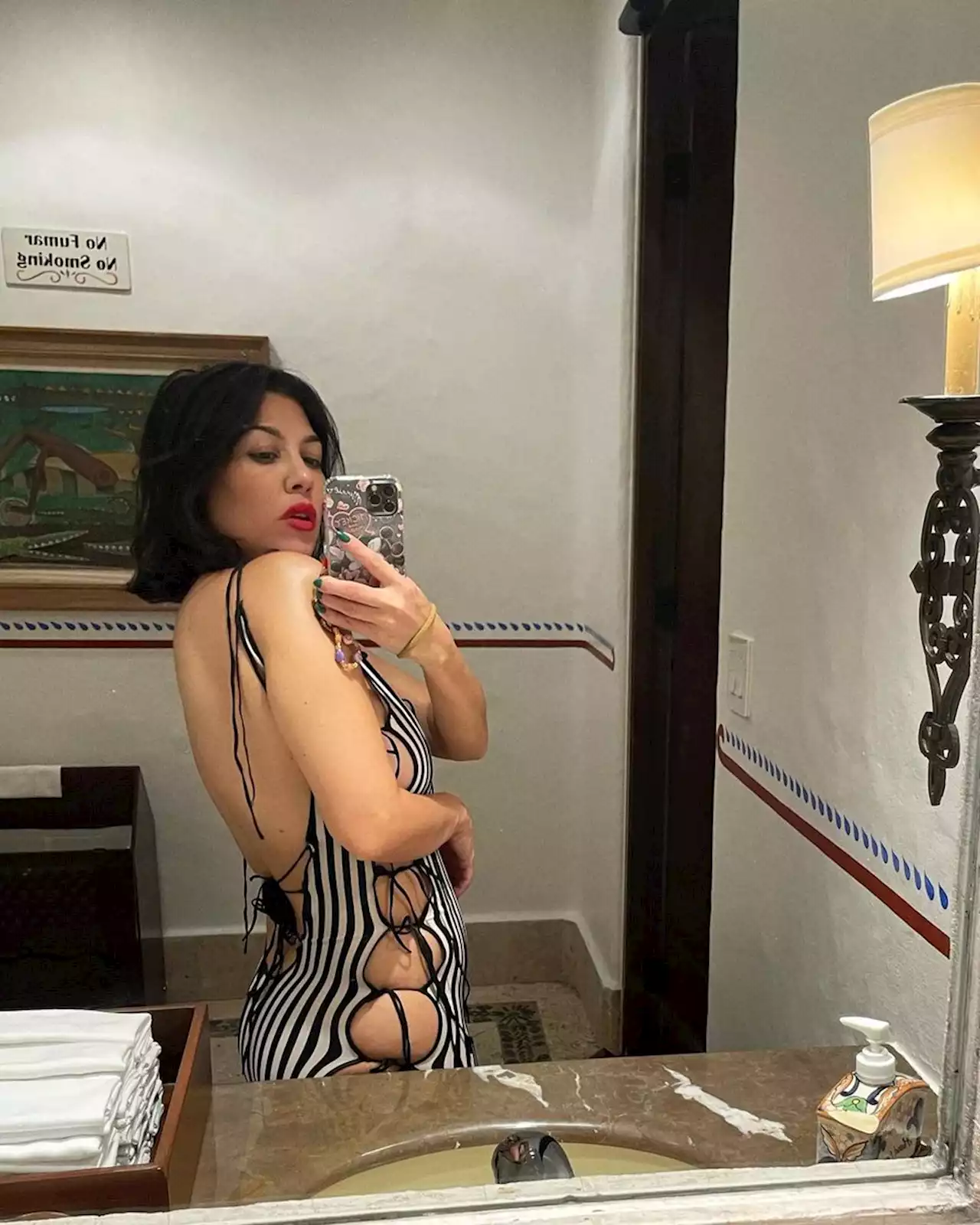 Kourtney Kardashian gives Beetlejuice vibes in side-boob-baring cutout dress