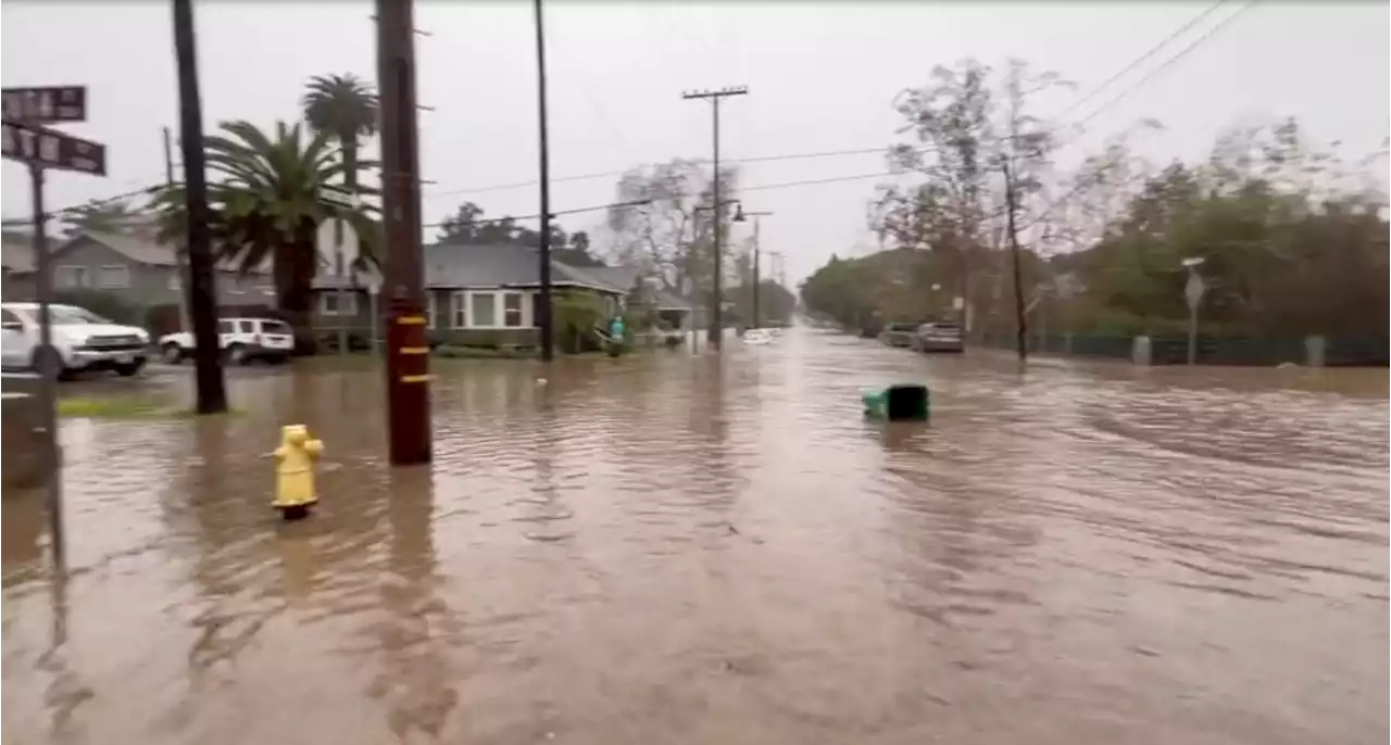 Kayakers paddle along flooded streets of Santa Barbara