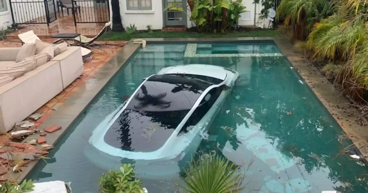 Three people, including a 4-year-old boy, are rescued after Tesla crashes into a pool