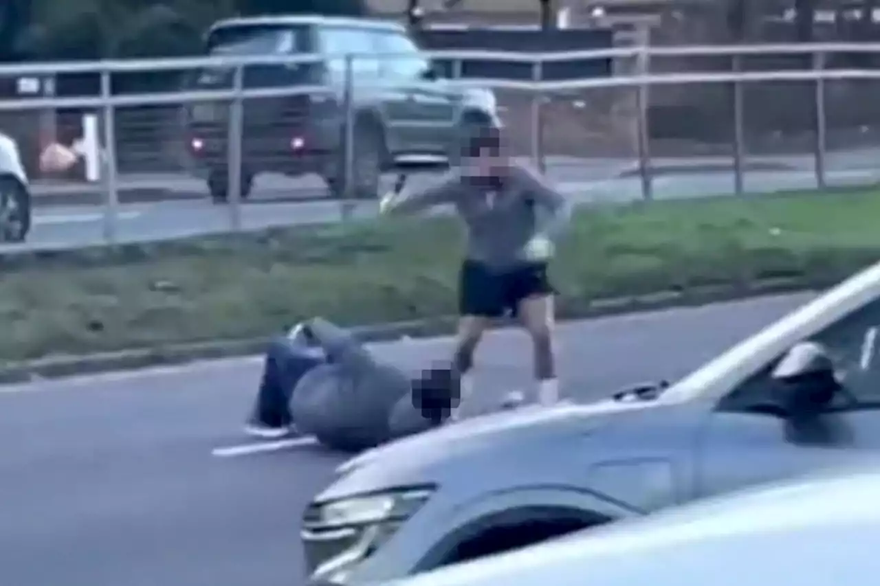 Moment two men swing blades at each other on busy road, leaving one critical