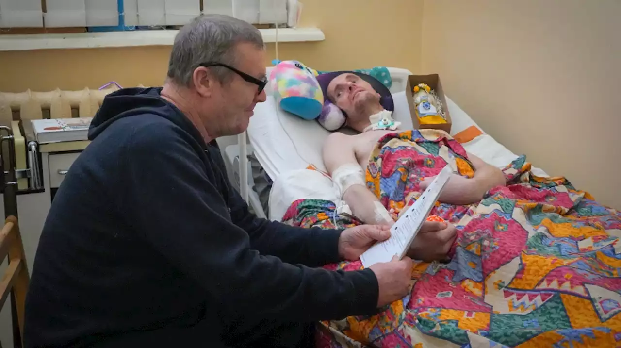 A loving dad and his injured son pay war's costs in Ukraine