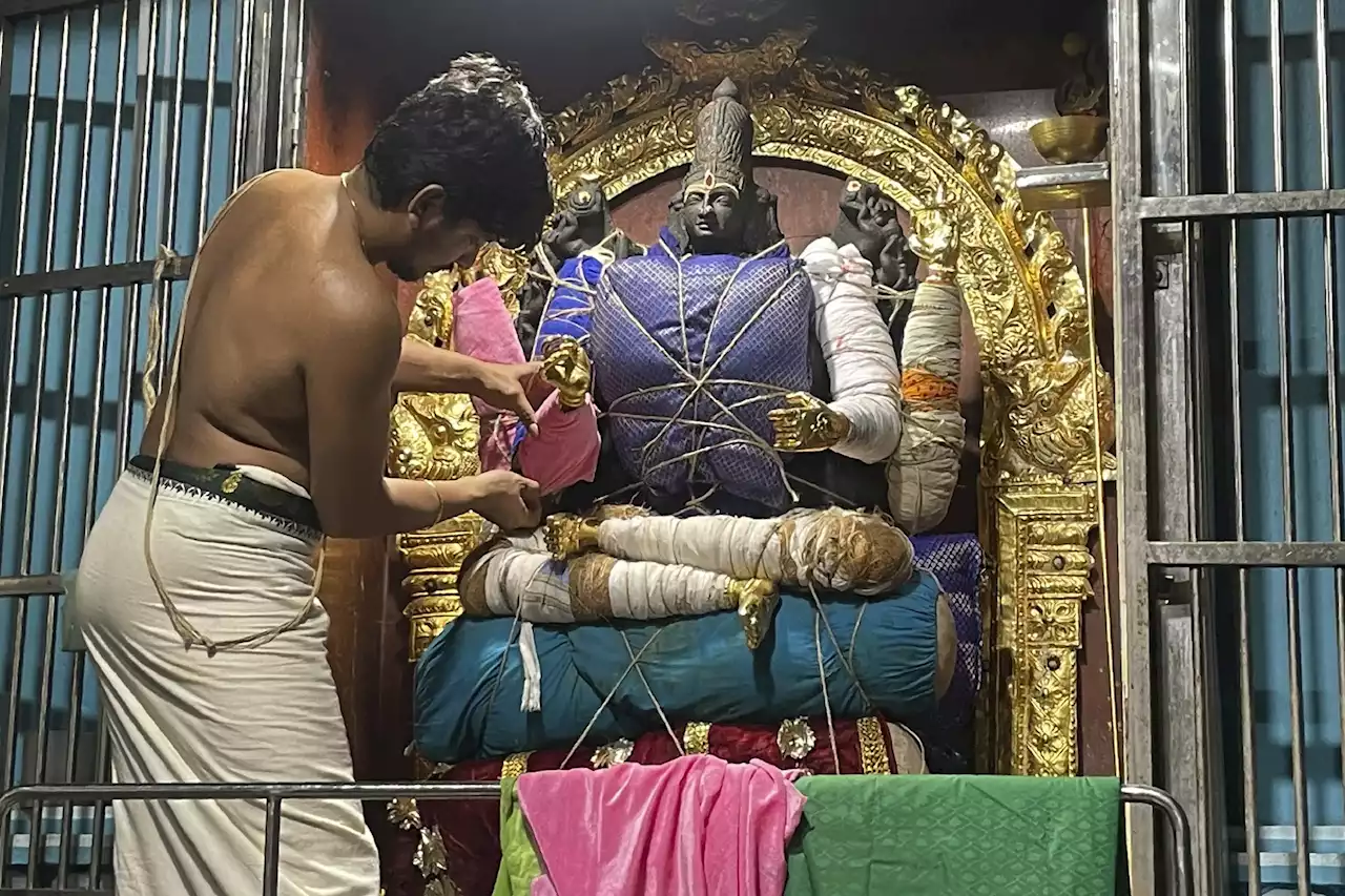 In India, deity decorating a calling for Hindu temple artist