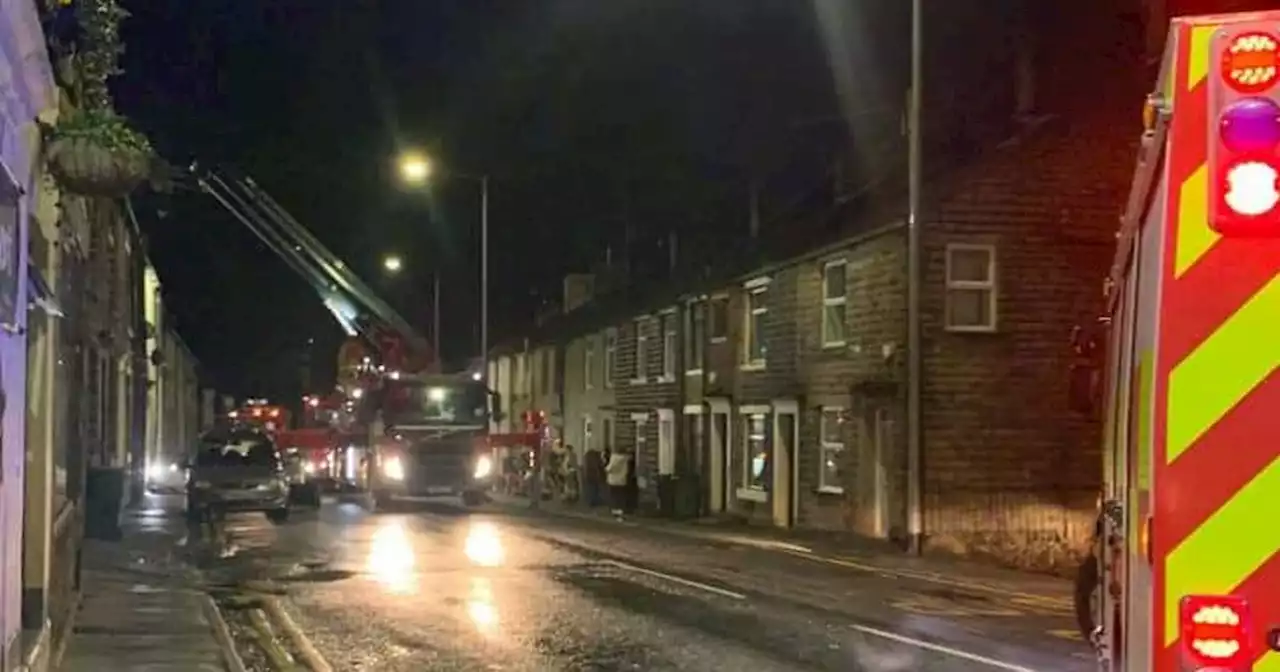 Fire spreads through terraced houses sparking major road closure