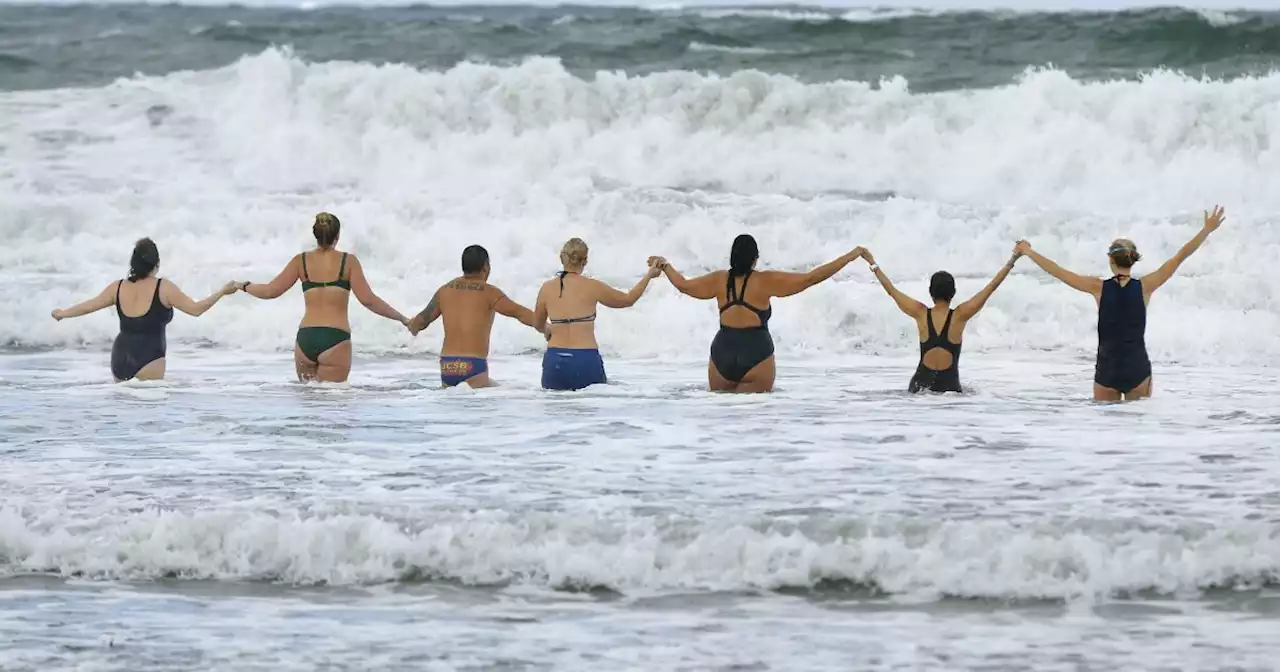 'Embrace the Popsicle toes': Despite wind and rain, dozens welcome new year with Polar Bear Plunge