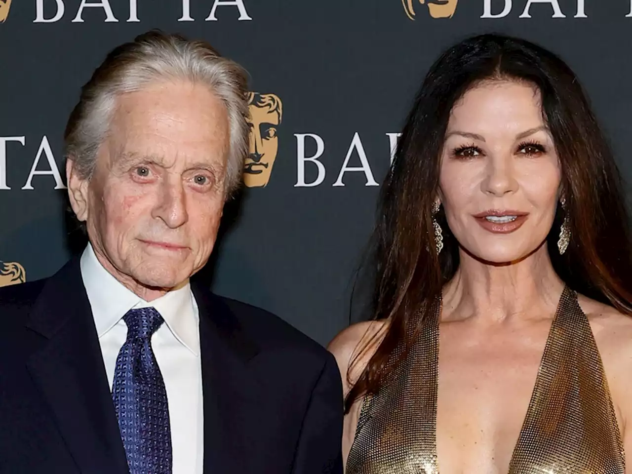 Catherine Zeta-Jones Looks Like the Epitome of Old Hollywood Glamour in Plunging & Spellbinding Gold Gown for BAFTA Bash