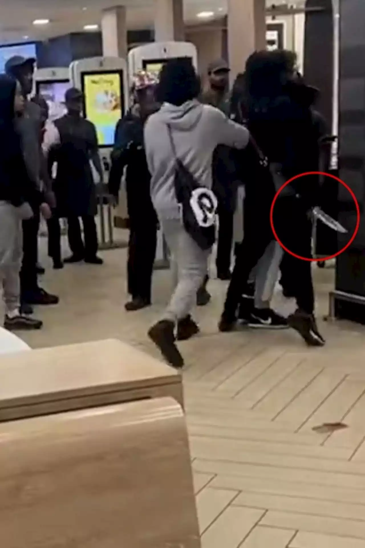 Shocking moment yobs brawl at McDonald's before one pulls out a huge knife