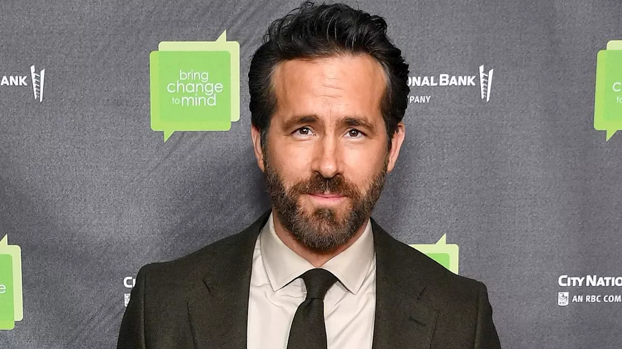 Ryan Reynolds sweetly embraces eldest daughter James, eight, during Wrexham AFC soccer game