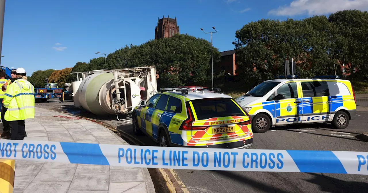 Road closed by police after concrete mixer flips over