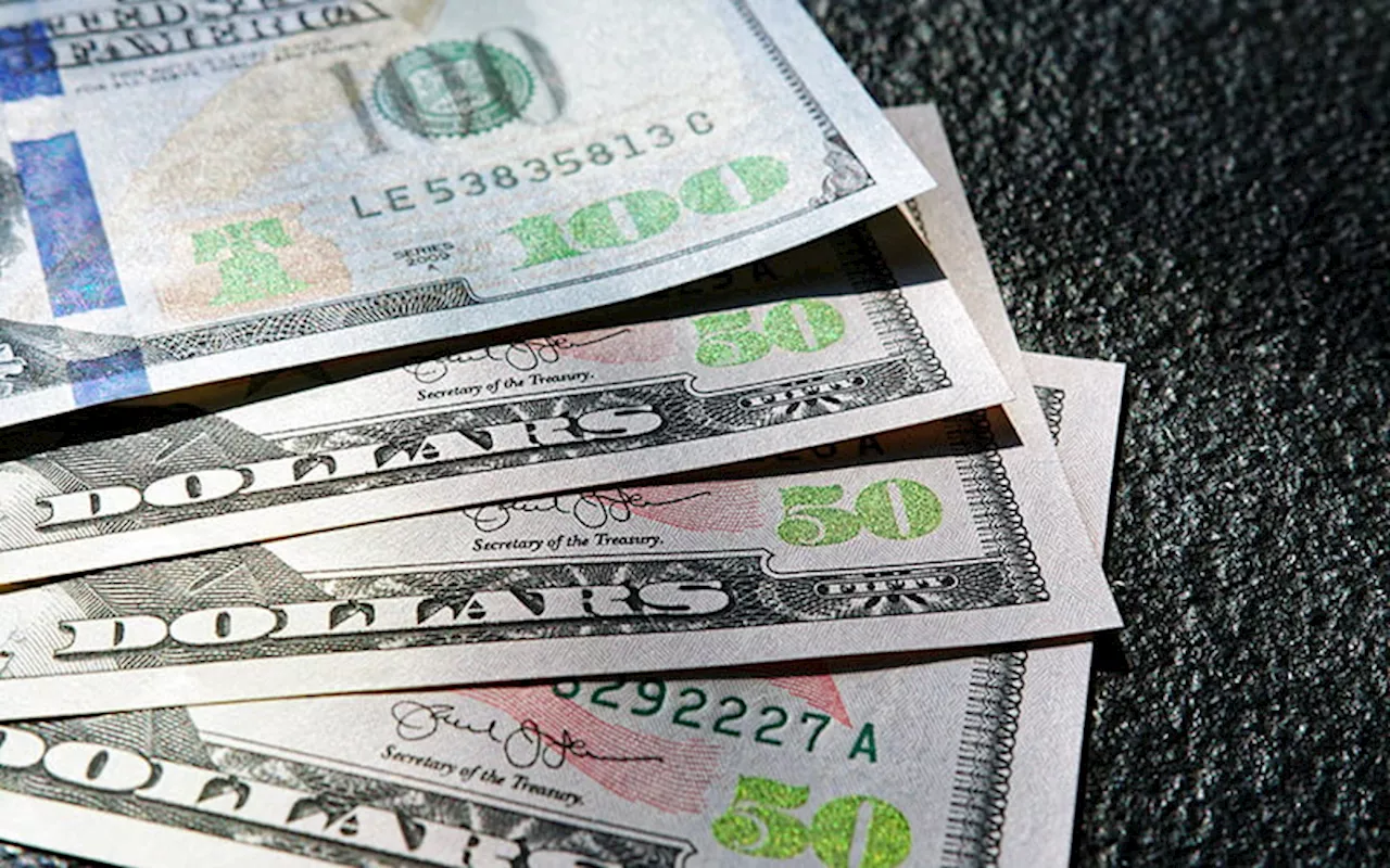 Dollar holds on to gains after firm US inflation data