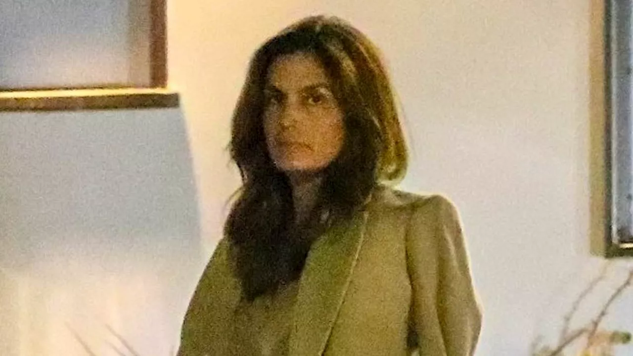 Cindy Crawford puts on a very stylish display in cream blazer and flared pants while shopping with...