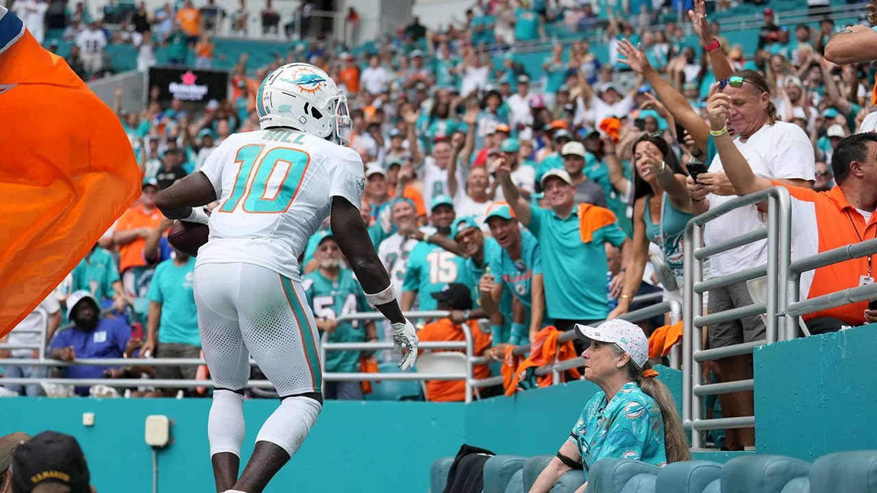 Tyreek Hill surprises fan with signed Dolphins gear after viral touchdown ball mix-up