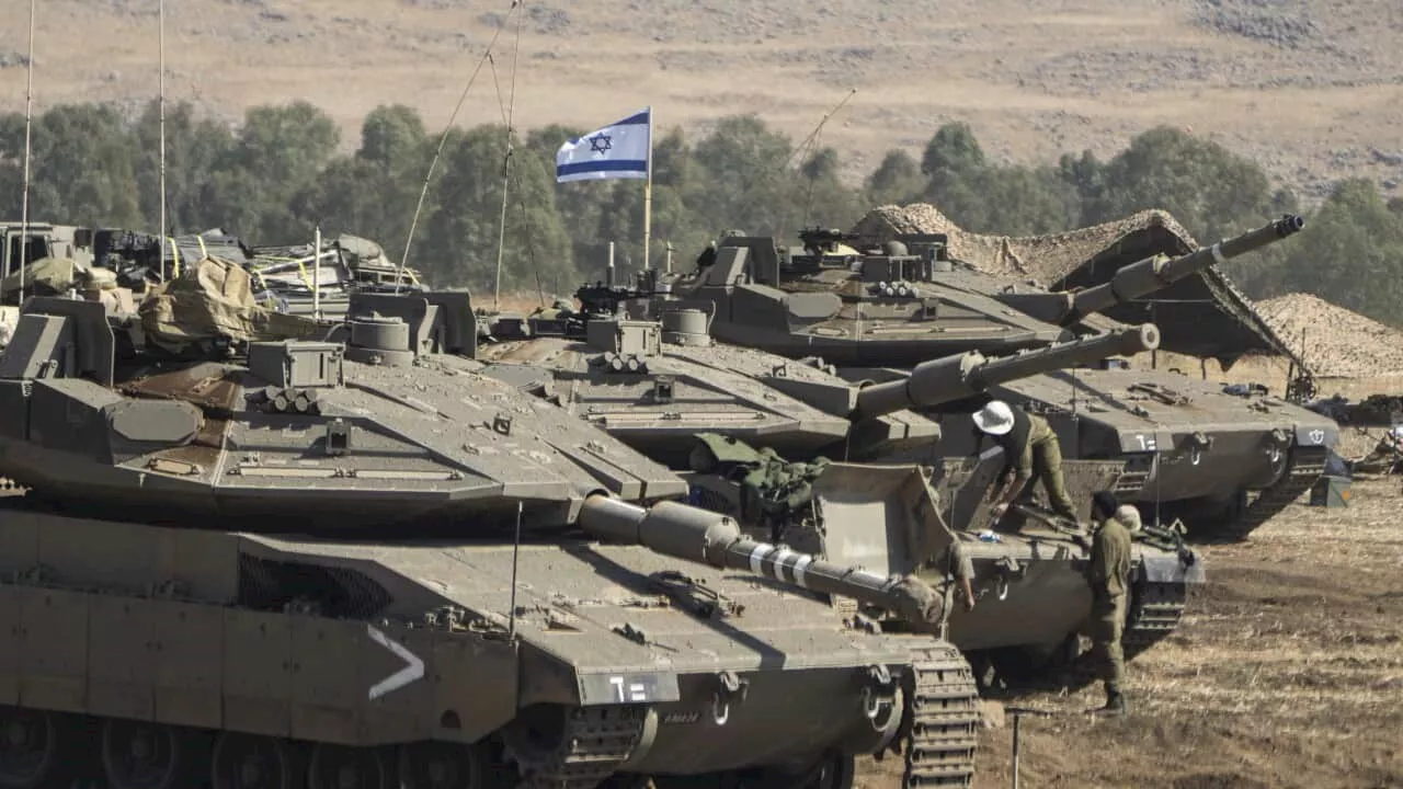 Israeli military prepares to attack Gaza by 'air, sea and land' as civilians flee