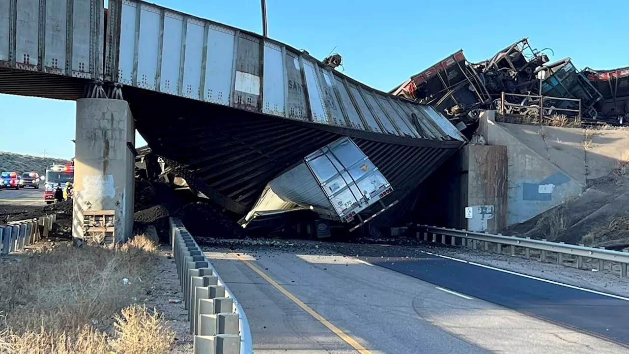 Truck driver killed when train derailment collapses Colorado bridge, spilling coal cars onto highway