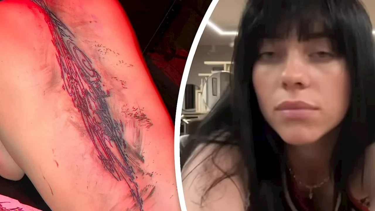 Billie Eilish shows off a massive new back tattoo prompting mixed reactions from baffled fans who...