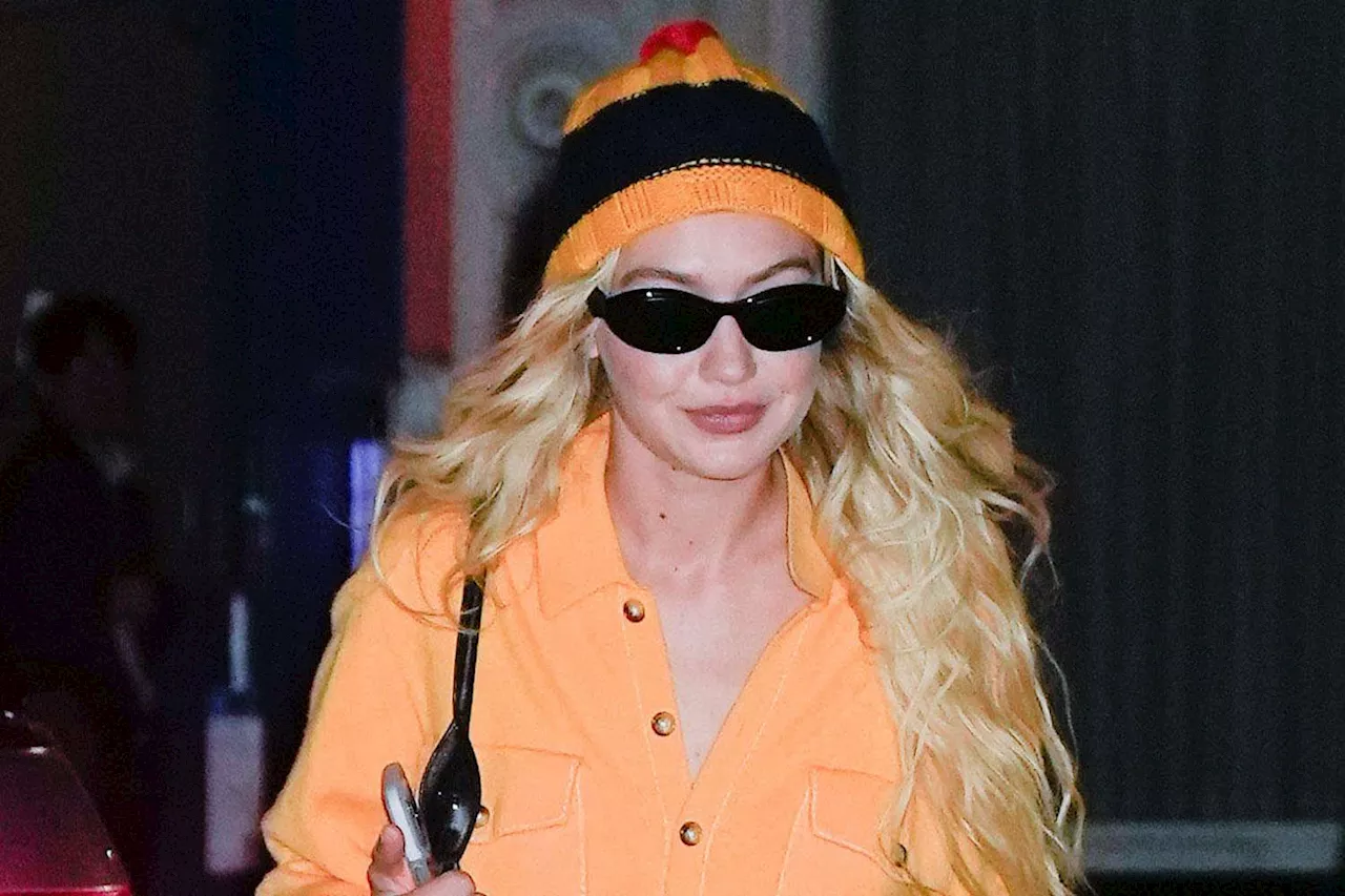 Gigi Hadid Steps Out in Bright Orange Boiler Suit and Matching Striped Pom Pom Hat