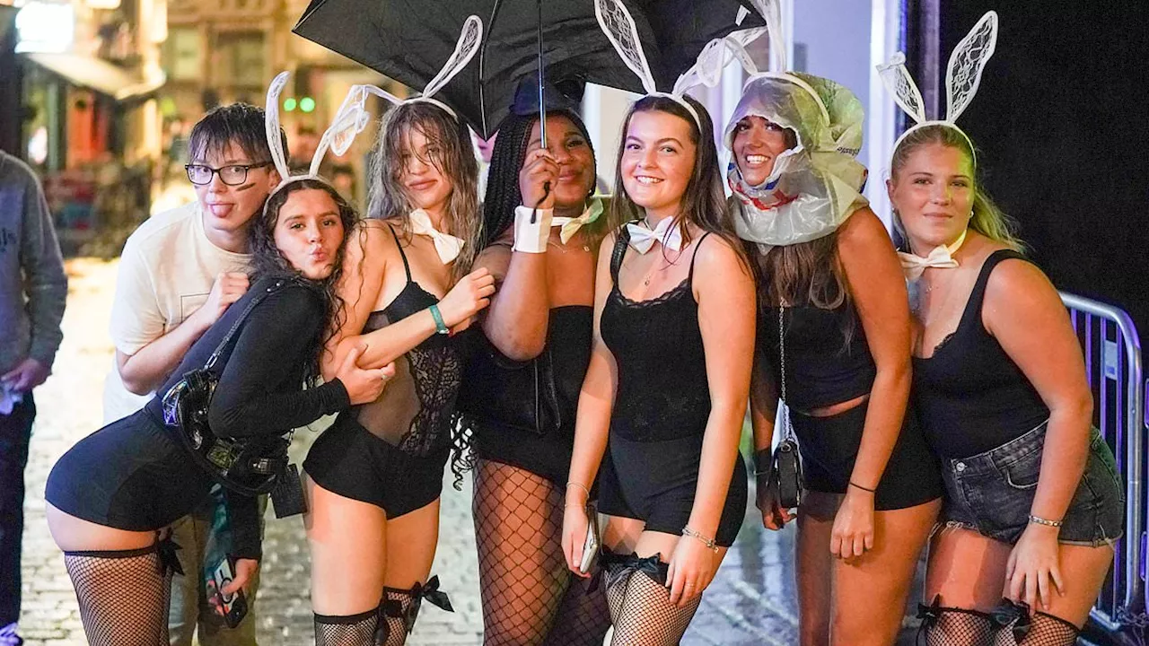 Braving Storm Babet! Nottingham students head to city's pubs and bars in fancy dress costumes during...