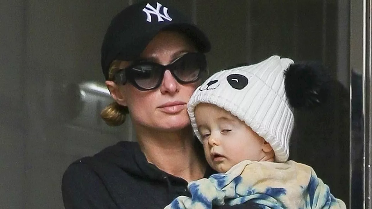 Paris Hilton cradles adorable baby son Phoenix, 9 months, as she steps out in NYC with husband...