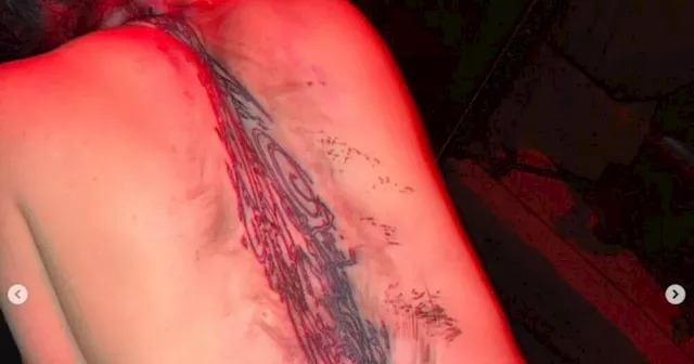 Billie Eilish unveils massive sci-fi back tattoo in latest