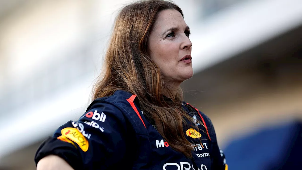 Drew Barrymore is all smiles while checking out pit row and interviewing racers during previews...