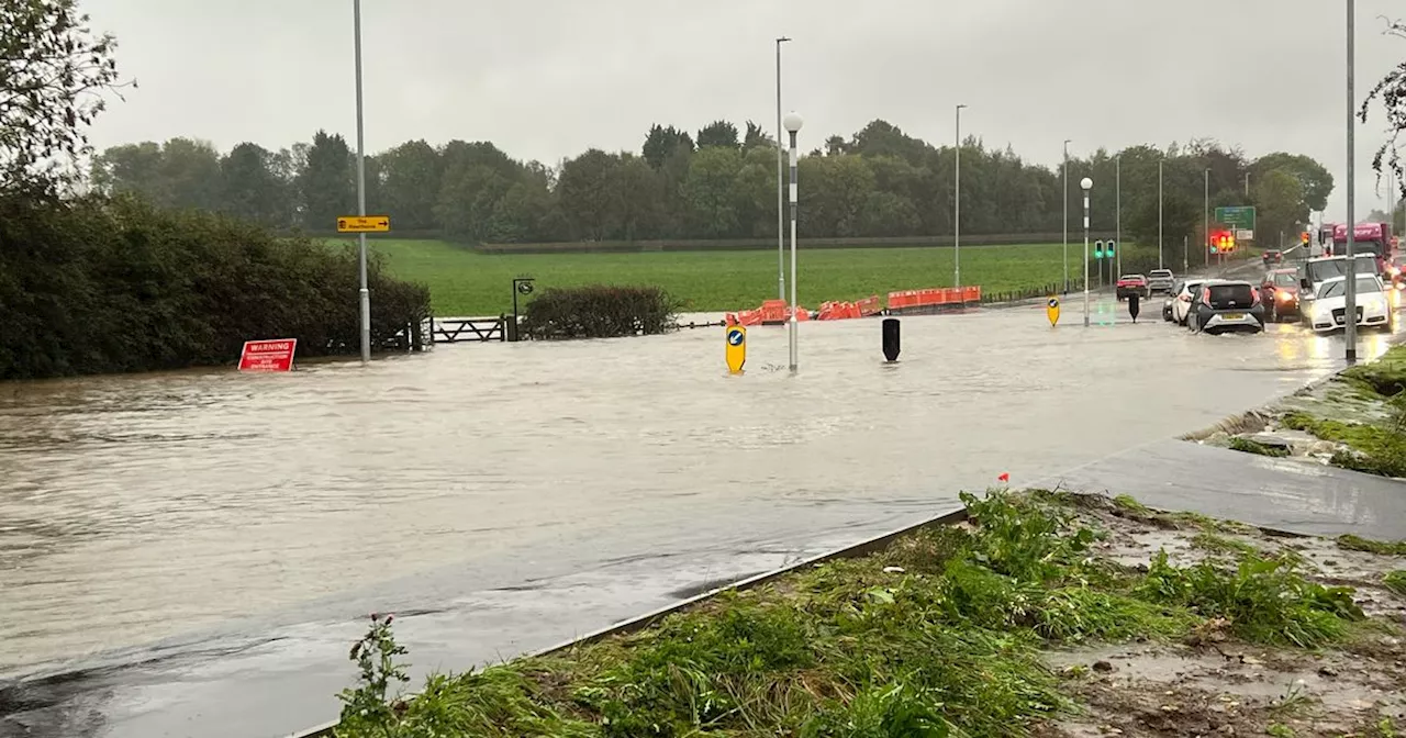 Main road closed due to flooding as 'cars abandoned'