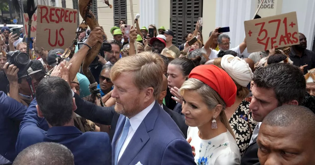 Dutch king and queen are confronted by angry protesters on visit to a slavery museum in South Africa