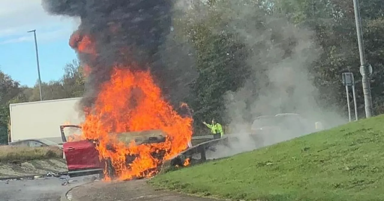 Car bursts into flames on busy Scots road as fire crews race to scene