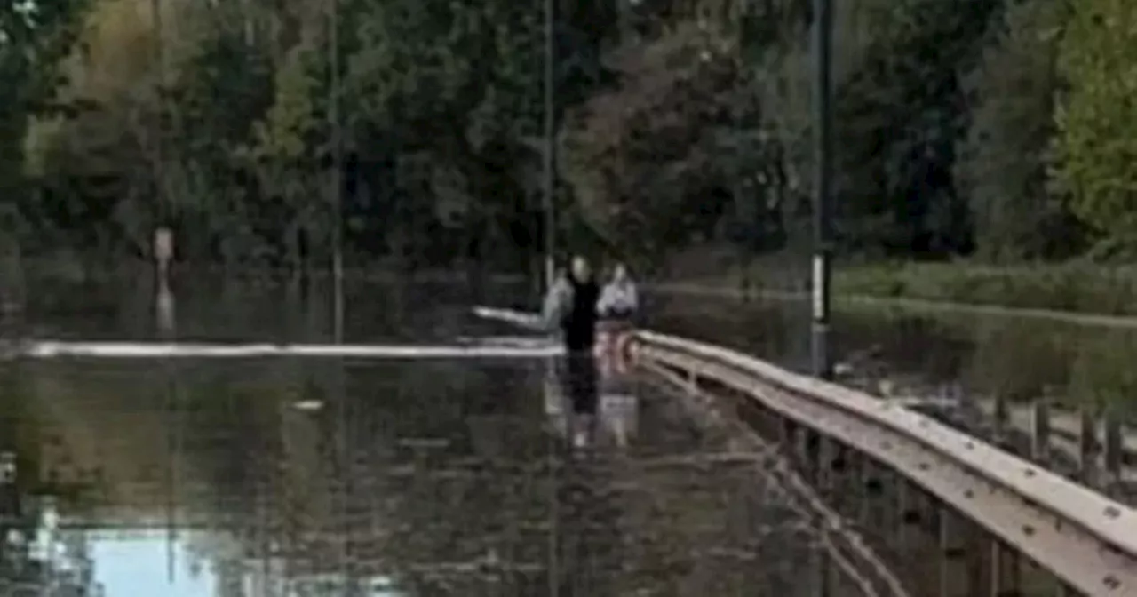 Police 'concerned' after woman seen walking in floodwater on A52