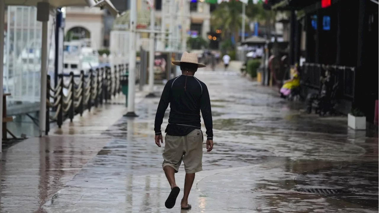 Large waves pound the northern Caribbean as Hurricane Tammy spins into open waters