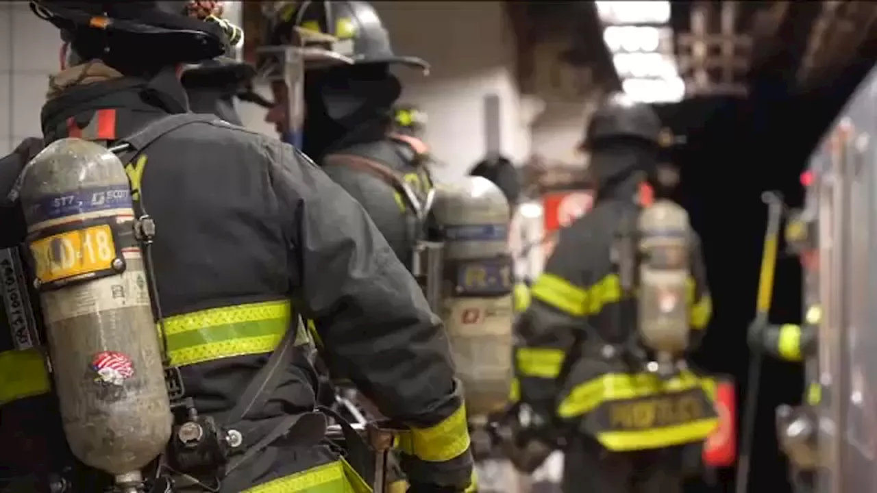 Firefighters work to put out subway track fire on 33rd Street near Grand Central Terminal