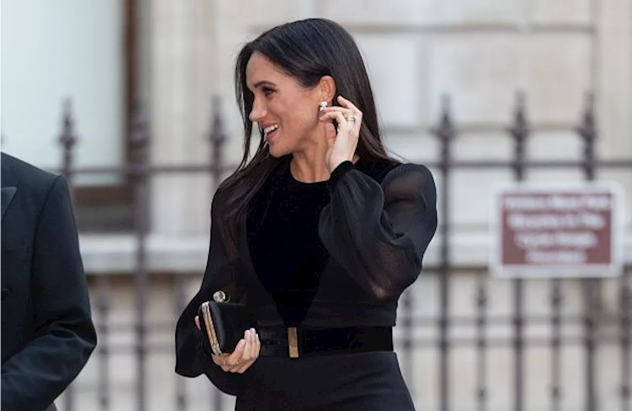 Meghan Markle just arrived to her first solo royal event, and her dress is AMAZING