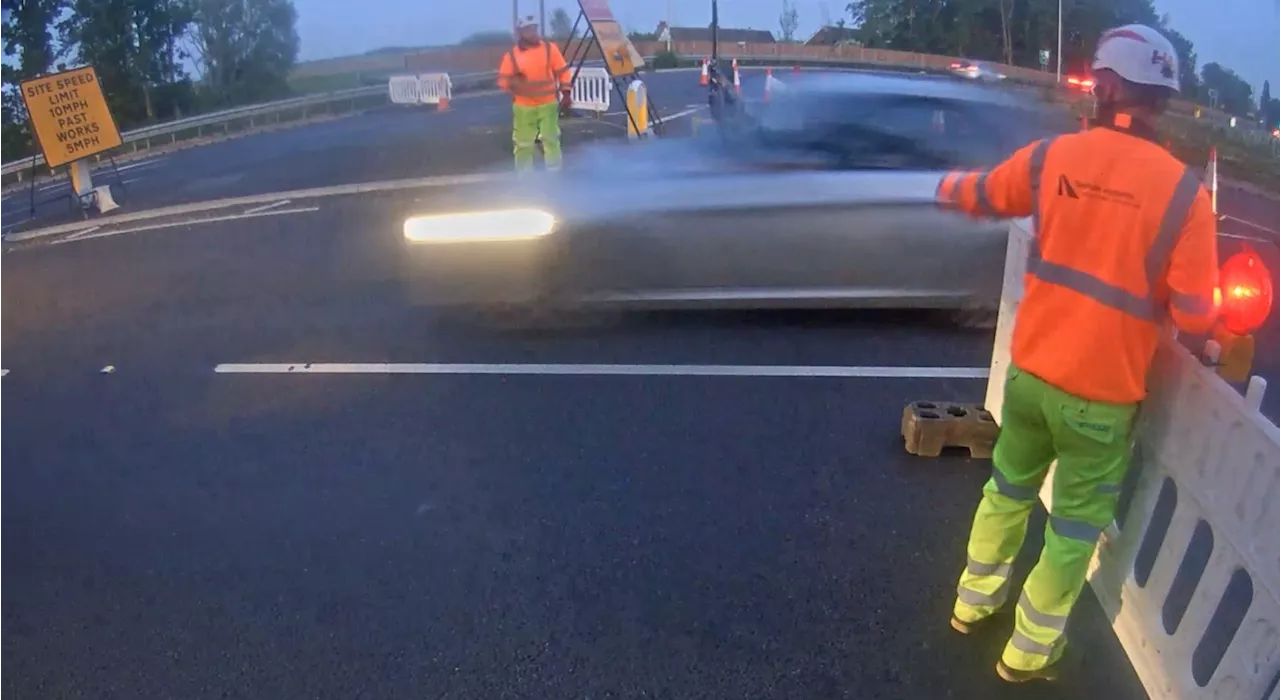 Video shows BMW driving through Cambridgeshire A47 roadworks as workers run for cover