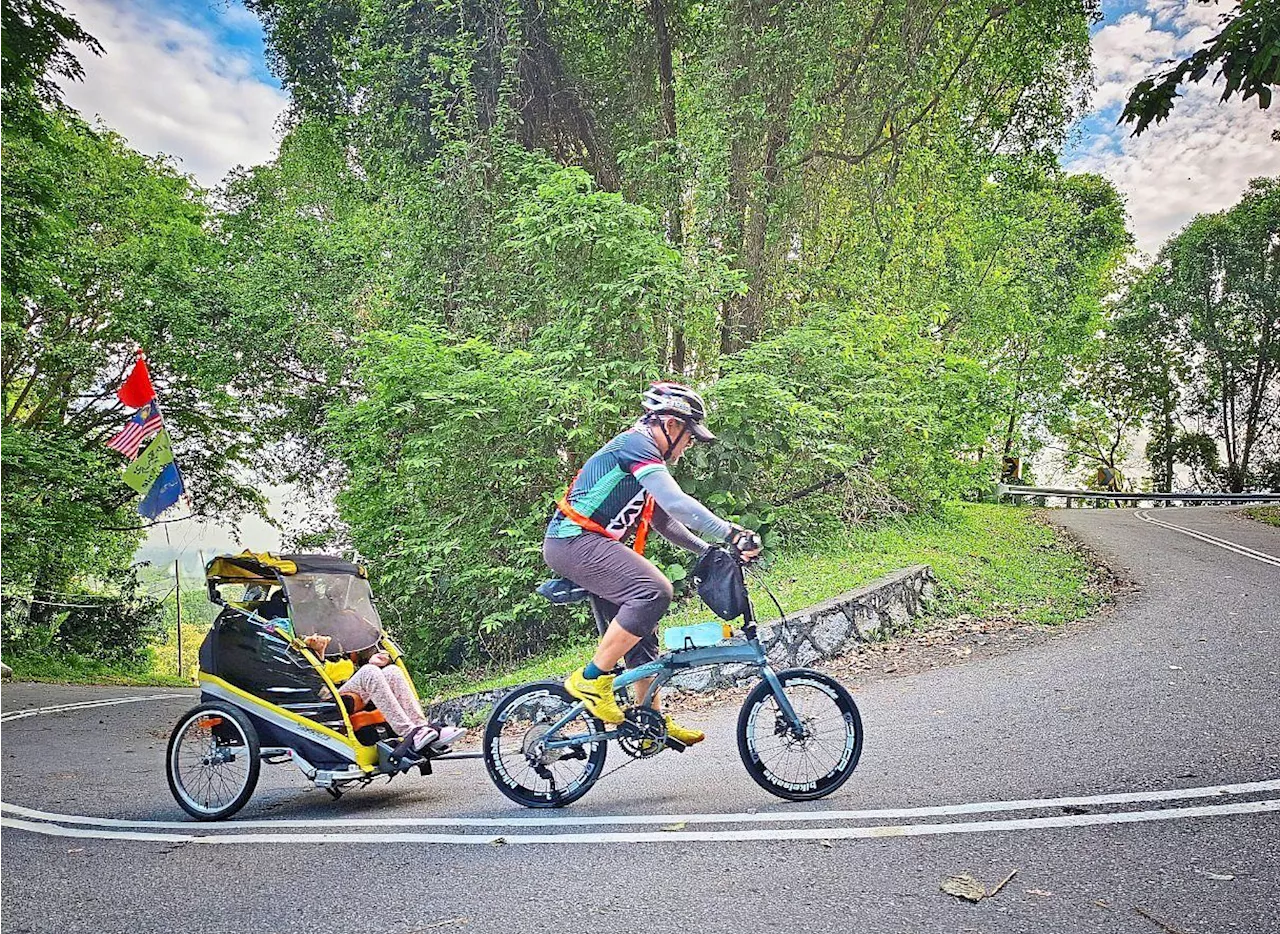 Malaysian man completes a half marathon with his cerebral palsy daughter